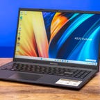 Asus VivoBook F1502ZA laptop on a wood table.
