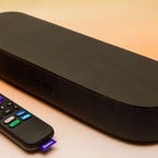 A black Roku Streambar and remote.