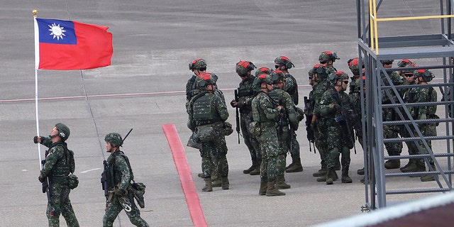 A Taiwanese soldier holding taiwan flag