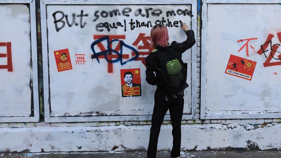 Pro-democracy activists and graffiti artists write over the Chinese slogans featuring Chinese Communist Party's core ideology on Bricklane, on August 06, 2023 in London, England.