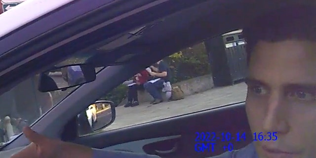 Bryan Kohberger tries to explain something to a police officer