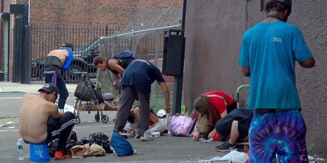 Drug users scatter across Kensington Avenue in Philadelphia's open-air drug market
