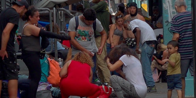 Child watches drug users injecting themselves with needles or stumbling through a busy road in Kensington