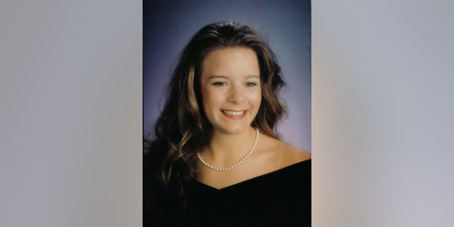 Christie Wilson wearing a black dress and pearls
