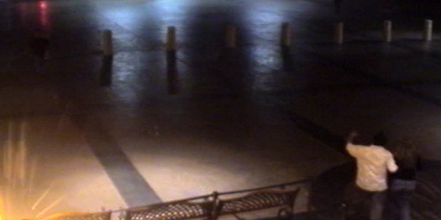 A screengrab of a parking lot with Mario Garcia wearing a white shirt
