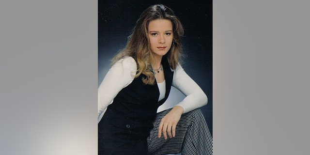 Christie Wilson wearing a white long sleeved shirt, a black vest and checkered pants