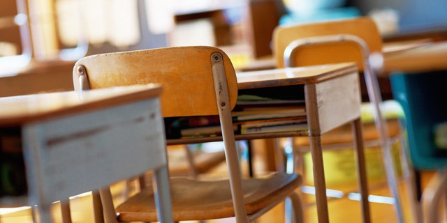 empty desks, chairs in classroom