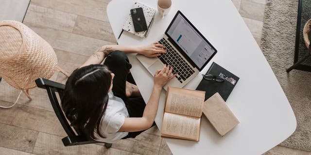 Woman using her laptop while stuyding.