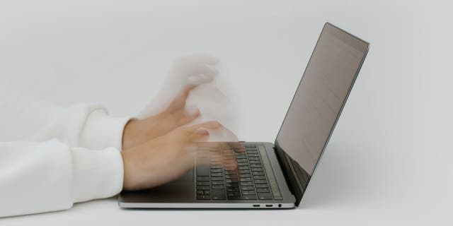 Person on their laptop, deleting apps.