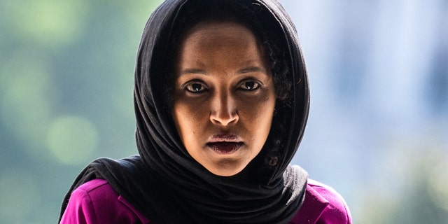 Rep. Ilhan Omar wearing hijab and purple blouse