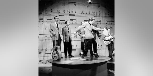 Elvis Presley wears suit during Ed Sullivan performance