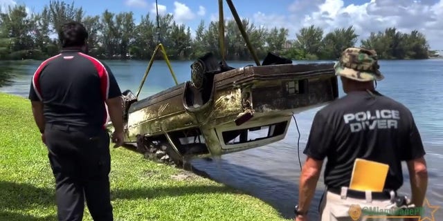 Pictured is a police handout of an old car being pulled from a lake in Doral, Florida