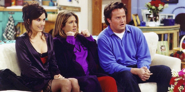 Courteney Cox, Jennifer Aniston and Matthew Perry filming a scene for Friends