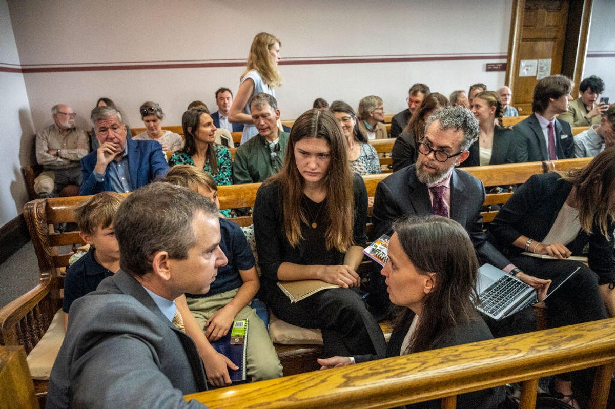 Lawyers and youth conferring in a Montana courtroom