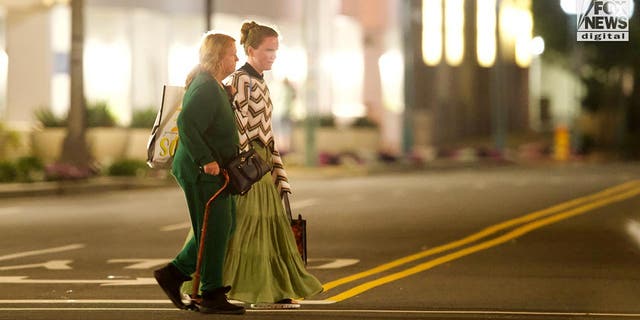 Rex Heuermann's wife, Asa Ellerup and daughter, Victoria Heuermann walk on the street