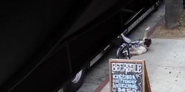 surveillance footage of woman falling off bus