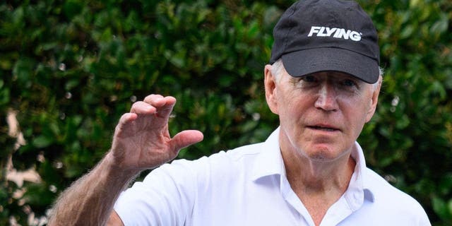 President Joe Biden waves