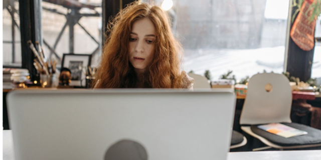 Woman works on laptop computer