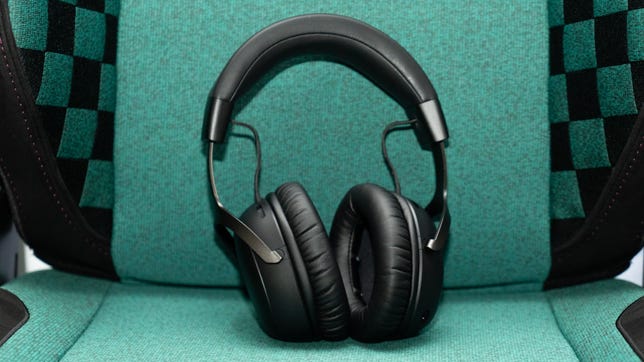 HyperX Cloud 3 Wireless without the mic leaning against the back of a green fabric gaming chair