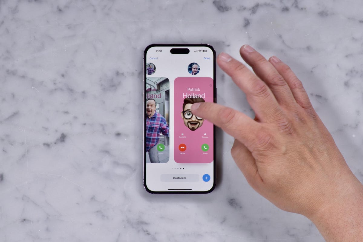 A hand editing a contact poster on an iPhone