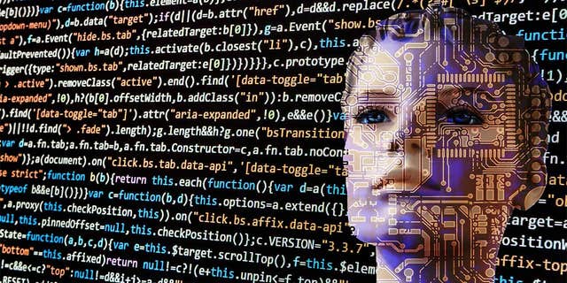 Photo of a bot looking at code.