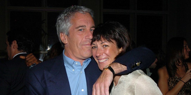 Jeffrey Epstein a black blazer and blue shirt embracing Ghislaine Maxwell in an ivory sweater