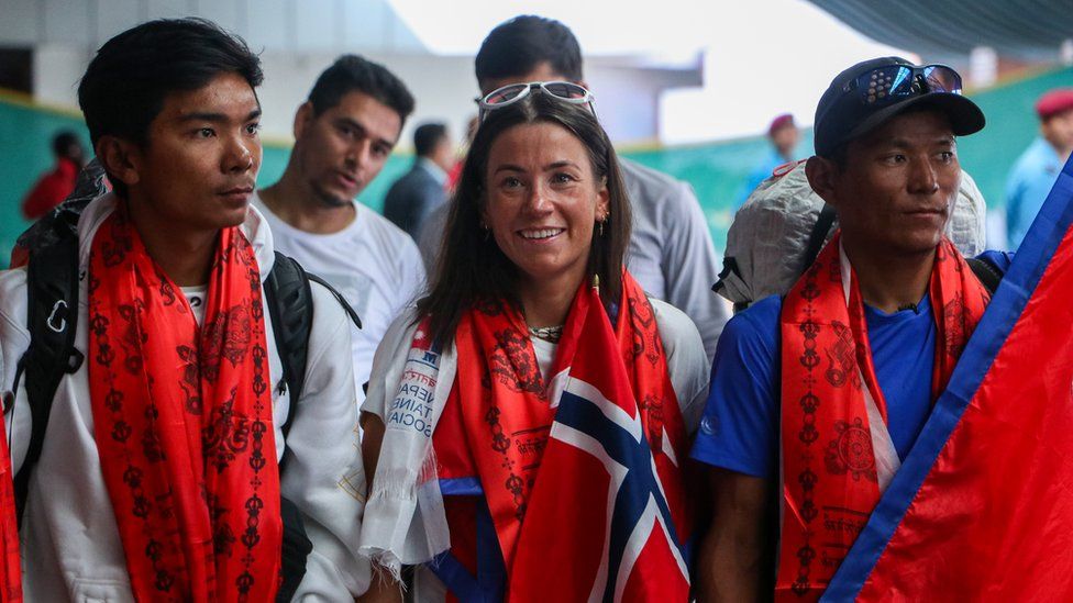 Norwegian climber Kristin Harila(C) and Tenjen Sherpa(L) at the Tribhuvan International Airport in Kathmandu on 5th August, 2023