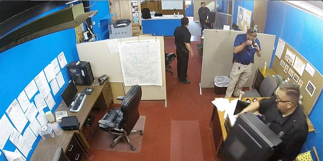 surveillance video shows Marion Police Department confiscating computers from the Marion County Record office in Kansas