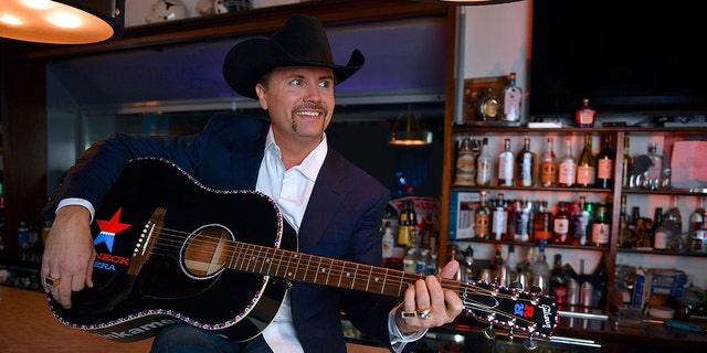 John Rich strums guitar at Redneck Riviera bar
