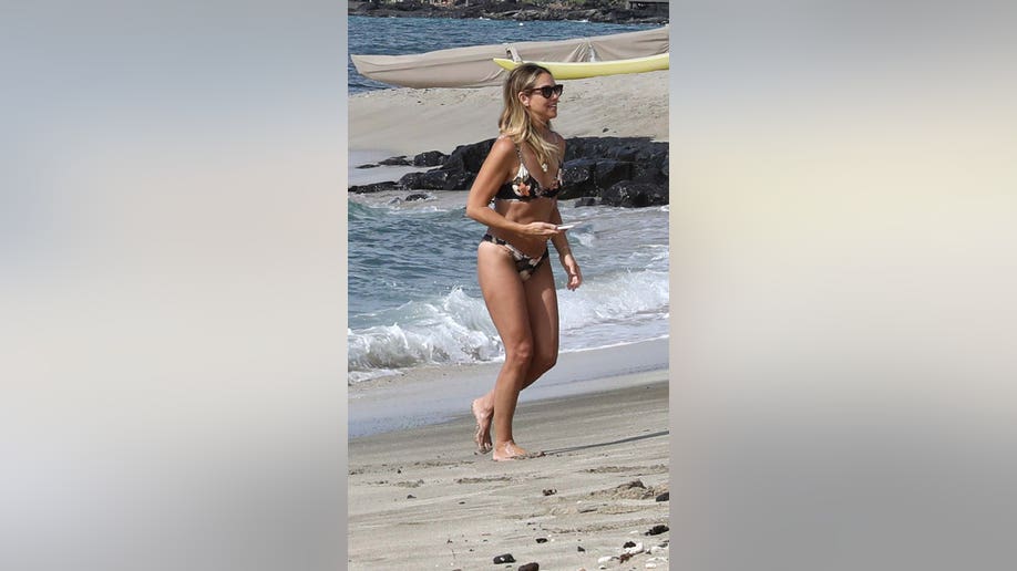 Christine Baumgartner walks on the beach