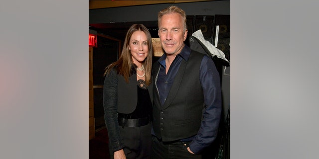 Kevin Costner and his wife Christine smiles for a photo at the OmniPeace Foundation in Los Angeles