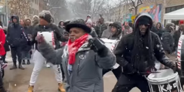 Lori Lightfoot dancing in winter coat outside