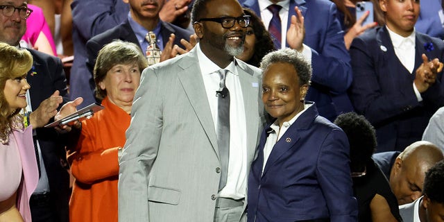 Brandon Johnson, left, stands with Lori Lightfoot at swearing-in ceremony