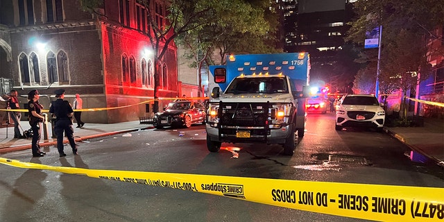 Ambulance parked behind crime scene tape