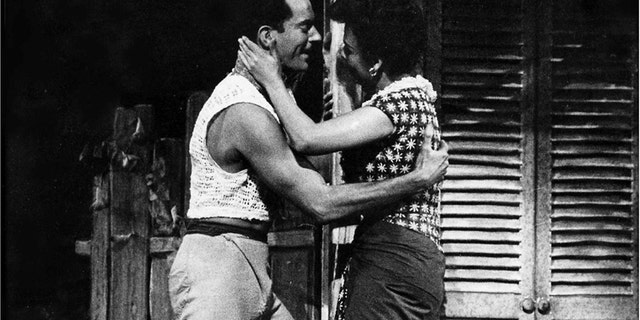 Alan Shayne embracing Lena Horne during a scene of Jamaica on stage