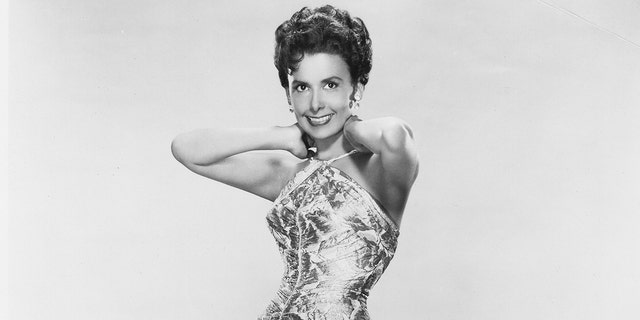 A close-up of Lena Horne in a criss-cross dress posing for a glamour shot