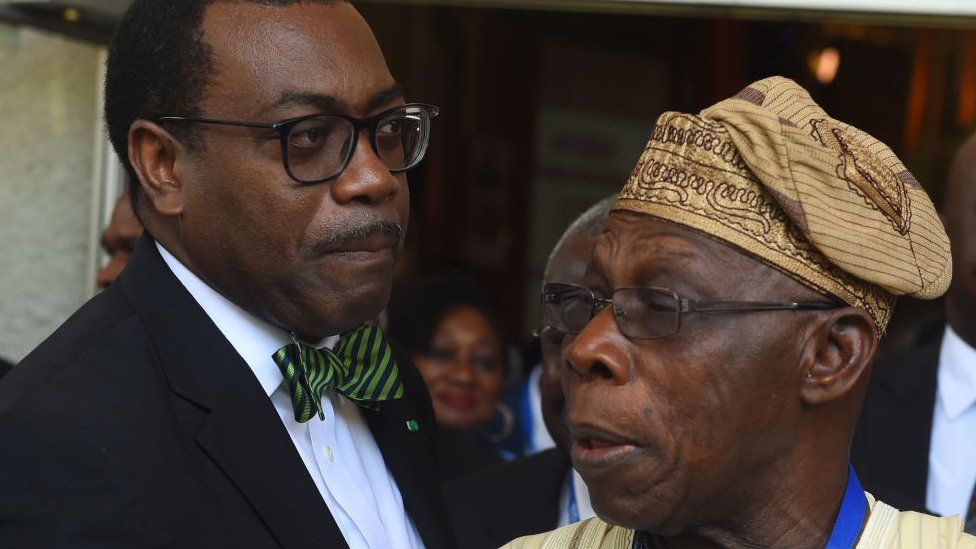 President of African Development Bank (ADB) Akinwumi Adesina (L) speaks with Nigeria's former President Olusegun Obasanjo in 2017