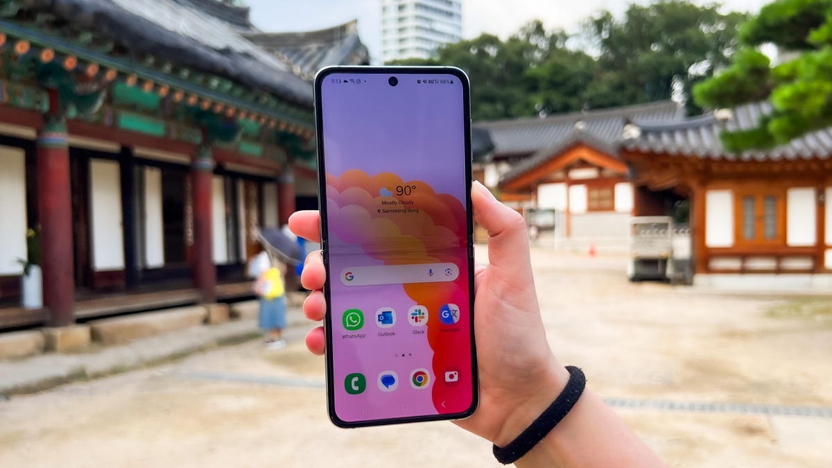 The Galaxy Z Flip 5 being held while open