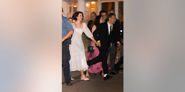 Margaret Qualley and Jack Antonoff run hand in hand after their wedding ceremony