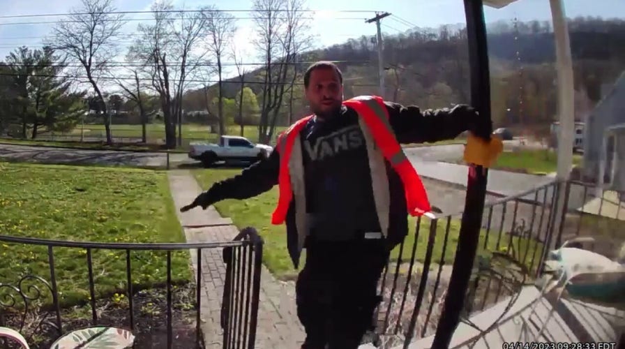 Camera captures homeowner blocking armed robber posing as delivery man
