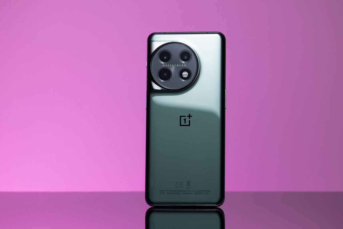 The OnePlus 11 5G standing up against a purple background