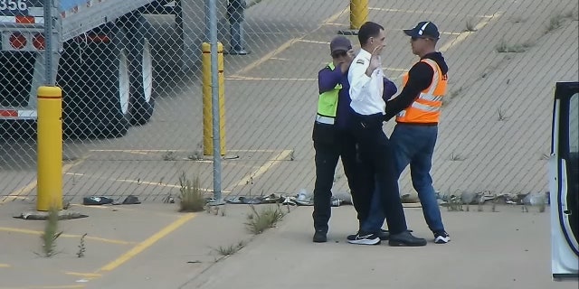 United Airlines pilot confronted by man in green vest, man in orange vest