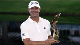 Lucas Glover holds the winner's trophy after winning the St. Jude Championship golf tournament Sunday, Aug. 13, 2023, in Memphis, Tenn. (AP Photo/George Walker IV)