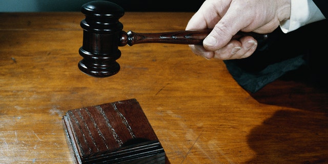 hand holding gavel stock image
