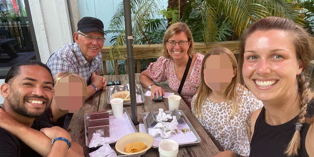 Group of people smiling at a table.