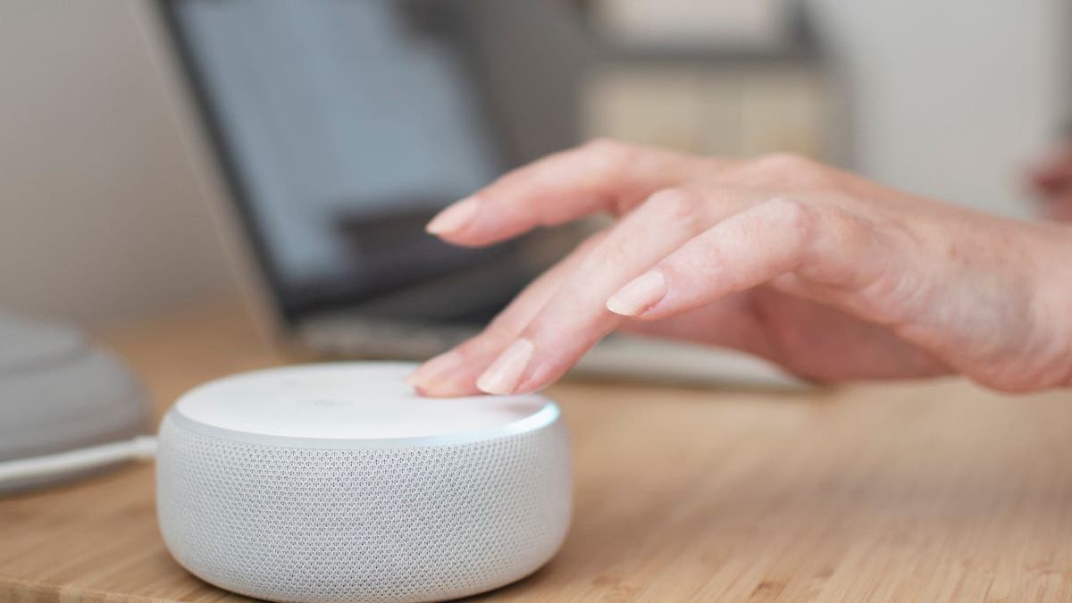 Woman turning on her home speaker.