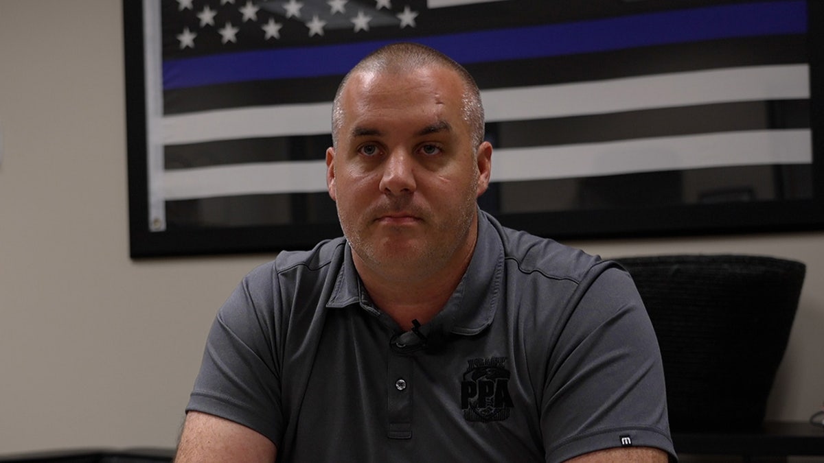 Portland Police Association president Aaron Schmautz sits in office