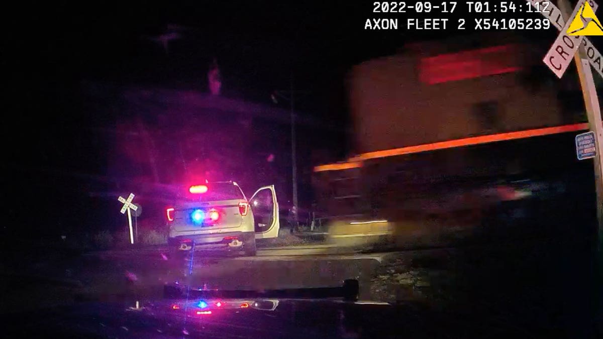 freight train strikes parked police car