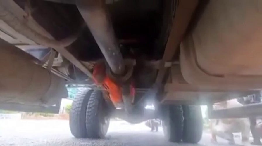 Filipino man shows police how he escaped from prison hiding under van