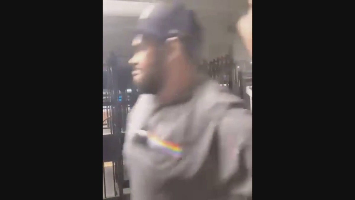 The suspect raises an umbrella to strike